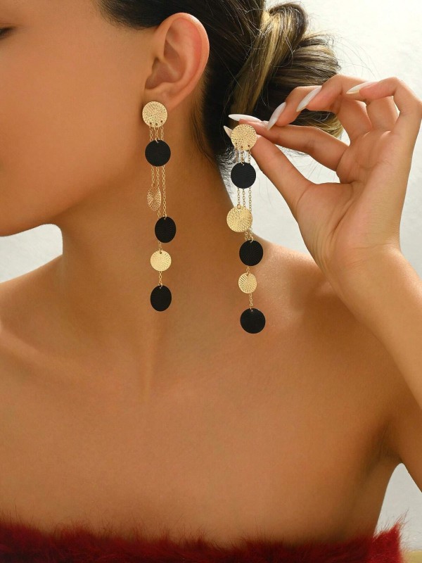 Kolczyki Black &amp; Gold Eclipse – długie złote kolczyki z czarnymi i złotymi krążkami, elegancka biżuteria o geometrycznym designie.