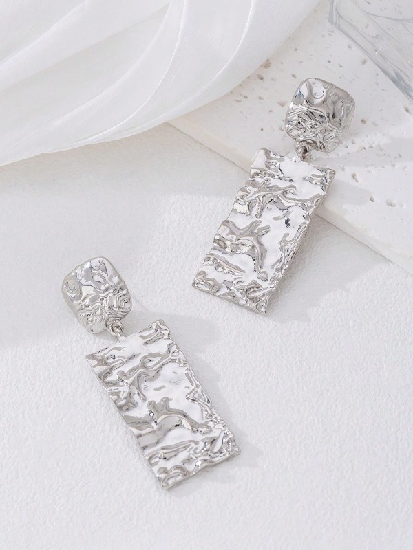 Srebrne kolczyki wiszące o prostokątnym kształcie z nieregularną, błyszczącą fakturą (1).webp