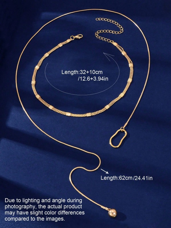 Złoty naszyjnik z podwójnym łańcuszkiem, geometryczną zawieszką i opadającym elementem zakończonym kulką (5).webp