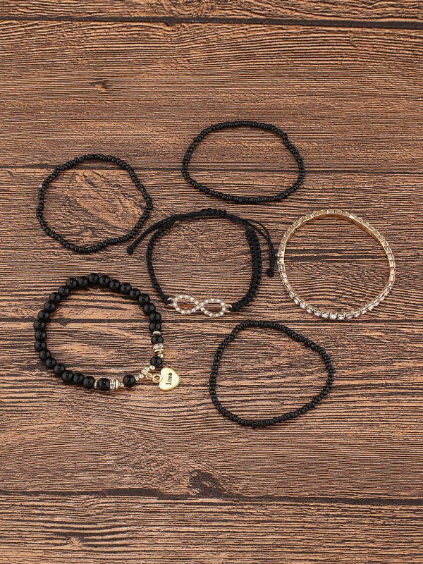 Zestaw czarno-złotych bransoletek z koralikami i elementami ozdobnymi (1).webp