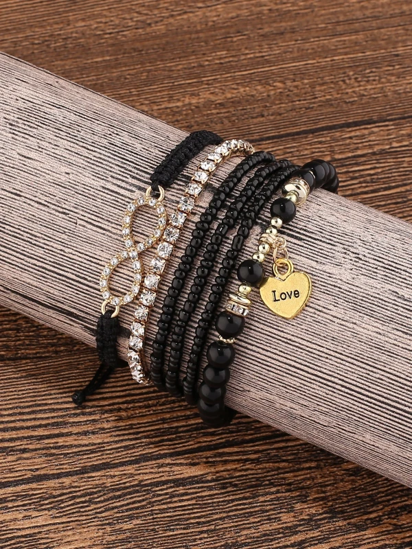 Zestaw czarno-złotych bransoletek z koralikami i elementami ozdobnymi (2).webp